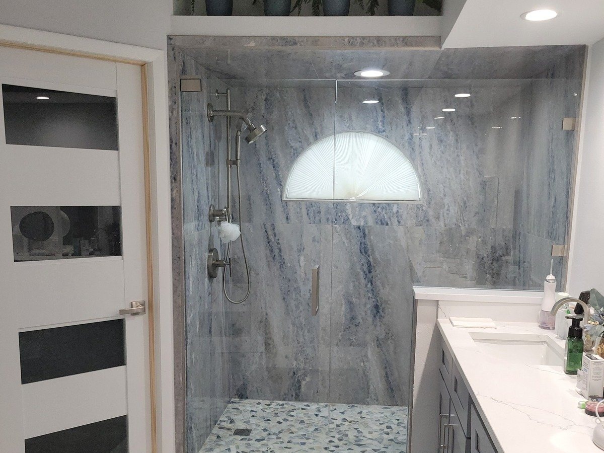 Finished bathroom remodel with tiled shower and vanity